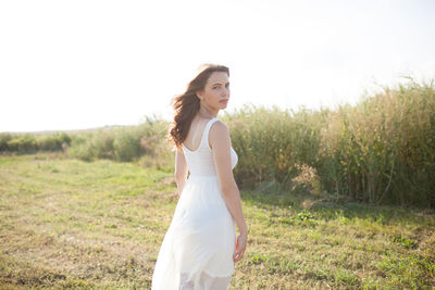 Portrait of woman standing on field
