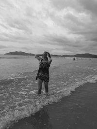 Rear view of woman walking on beach