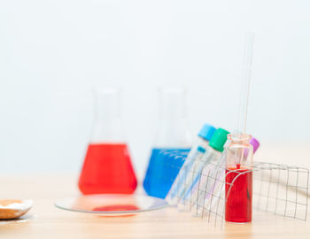 Close-up of glasses on table against white background