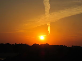 Scenic view of silhouette mountains against sky during sunset