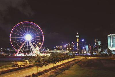 Illuminated ferris wheel at night