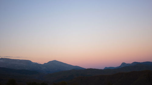 Scenic view of mountains against sky during sunset