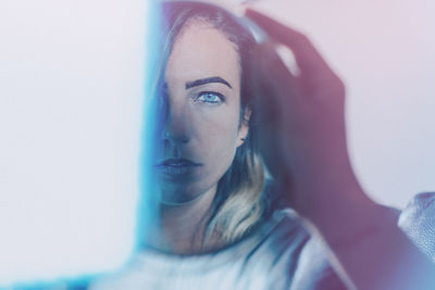 Portrait of beautiful young woman against white background