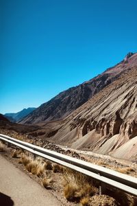 Scenic view of mountains against clear blue sky