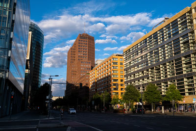 Street amidst buildings against sky in city