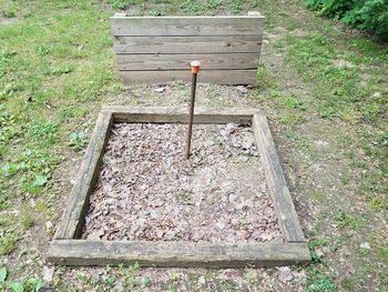 High angle view of wooden bench on field