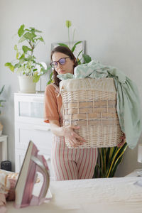 Portrait of smiling young woman in wicker basket