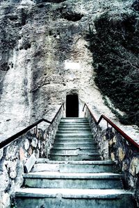 Low angle view of staircase in old tunnel