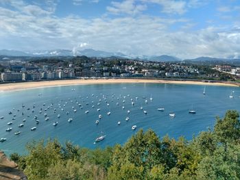 High angle view of townscape by sea against sky