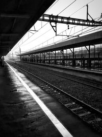 Train at railroad station against sky