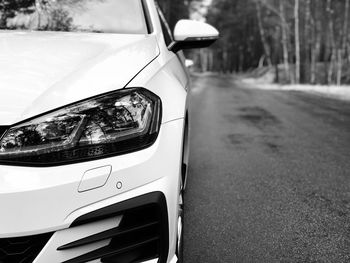 Close-up of car on road