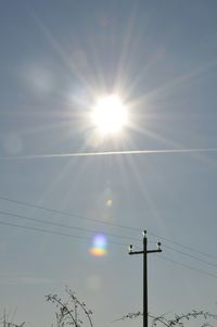 Low angle view of sun shining in sky