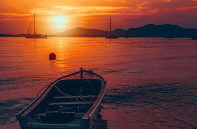 Boat sailing in sea during sunset