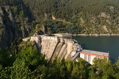 High angle view of dam by river amidst trees