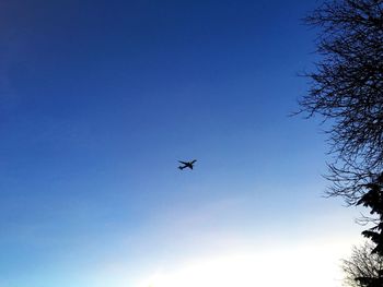 Low angle view of airplane flying against clear sky