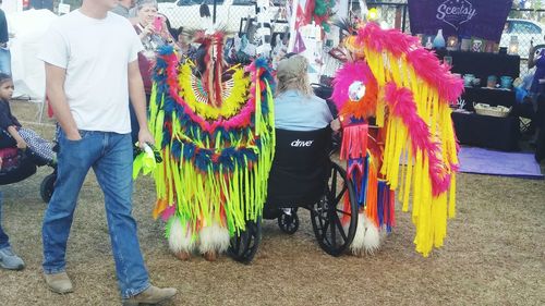 Rear view of people standing outdoors