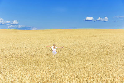 Full length of man standing on field against sky