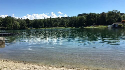 Scenic view of lake in forest against sky