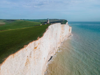 Photo of bell tout lighthouse along the cliffs of the seven sisters in the united kingdom.