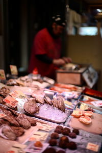 Man working on barbecue grill at market