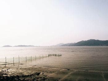 Scenic view of beach against clear sky