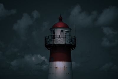 Lighthouse against sky at night