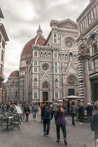 Group of people in front of buildings in city