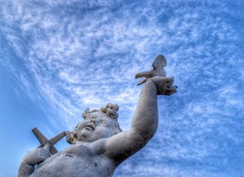 Low angle view of statue against cloudy sky