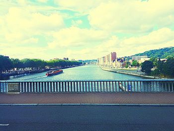 Scenic view of river against sky in city