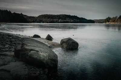 Rocks in sea against sky