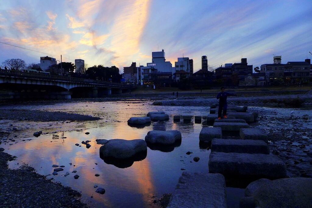 water, sunset, sky, reflection, architecture, built structure, building exterior, cloud - sky, rock - object, cloud, lake, silhouette, river, nature, stone - object, dusk, city, tranquility, scenics, beauty in nature