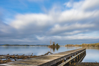 Pier over lake against sky