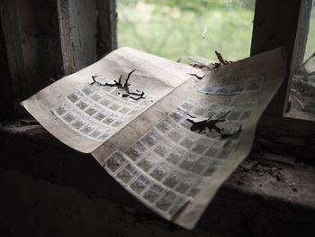 Close-up of abandoned postage stamps on window sill