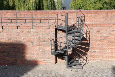 Spiral staircase against brick wall