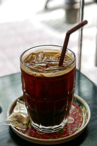 Close-up of coffee in glass on table