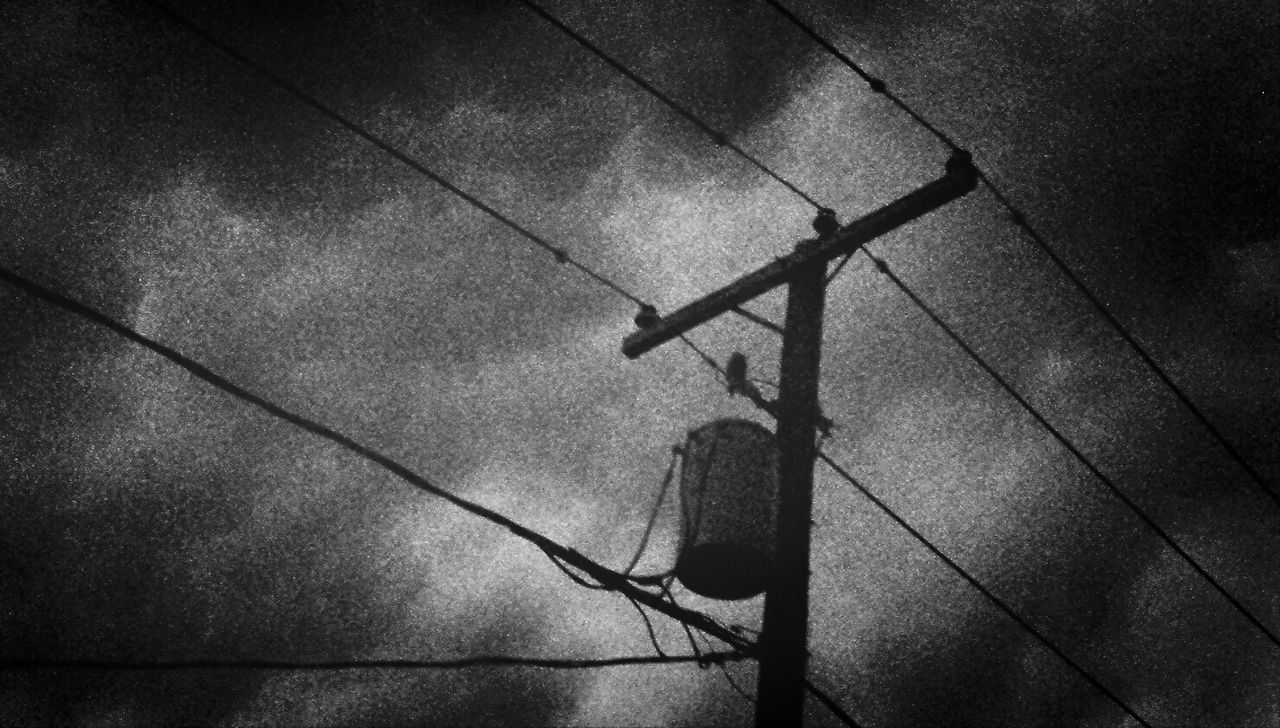 power line, power supply, electricity, high angle view, cable, low angle view, connection, no people, day, shadow, wall - building feature, outdoors, sunlight, metal, safety, electricity pylon, fuel and power generation, sky, silhouette