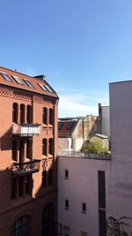 Buildings in city against blue sky