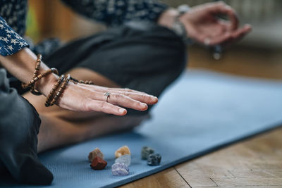 Low section of woman meditating at home