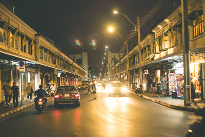 Cars on city street at night