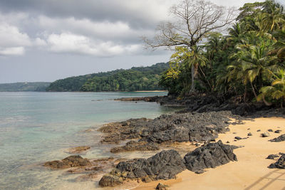 Scenic view of sea and mountains against sky