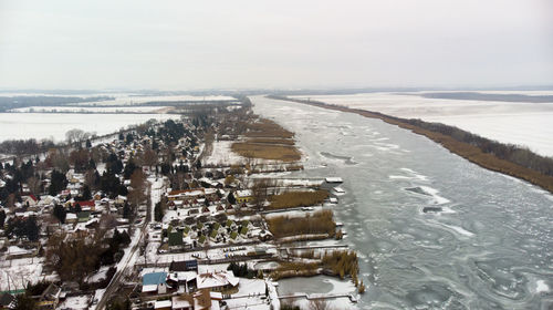 High angle view of cityscape during winter against sky