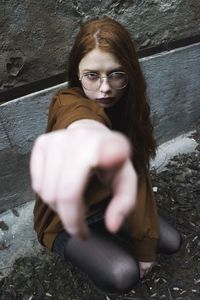 Portrait of a young woman holding camera