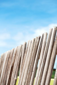 Low angle view of wooden fence against sky