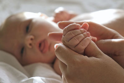 Baby hand in mother hands. newborn baby tiny fingers, close up. maternity, family, birth. infant. 