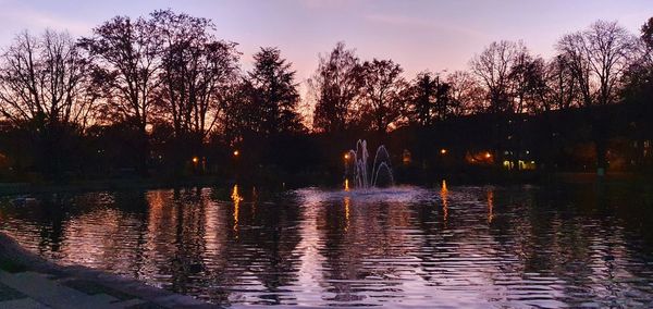 Scenic view of lake against sky at sunset