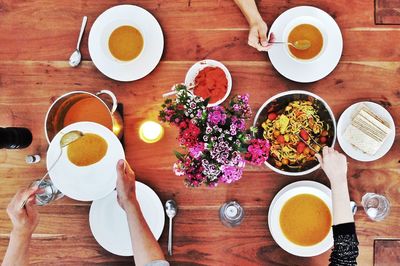 Directly above view of people enjoying soup