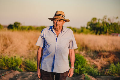 Man wearing hat standing on field