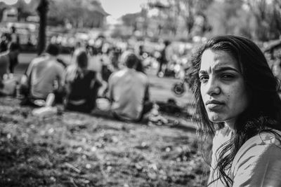 Portrait of a young woman looking away outdoors