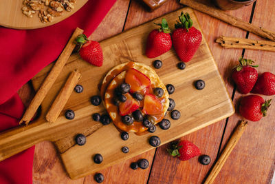 High angle view of strawberries on cutting board