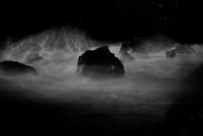 Low angle view of waterfall against sky at night